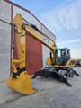 2007 Caterpillar M318D wheel excavator, front three-quarter view