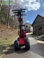 2023 Schäffer 2628 mini excavator, front view with raised loader arms