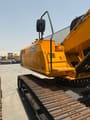 2025 JCB 225 Crawler Excavator showing the yellow engine cover and side steps from a rear three-quarter view.