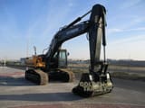 2023 Hyundai HX360L Crawler Excavator with its black boom and arm positioned to the right, highlighting the bucket.