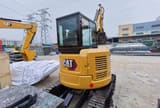 2023 Caterpillar 303.5E mini excavator, rear three-quarter view