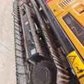 2025 Sany SY135H Crawler Excavator with a close-up view of the black track assembly and yellow body.