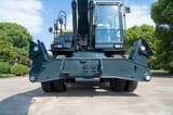 2026 Hyundai HW210 Wheel Excavator with a close-up view of the rear outriggers and undercarriage