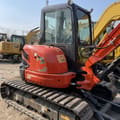 2026 Kubota U40-3 Mini Excavator with a close-up view of the operator's cab and engine cover showing U-40 decal.