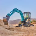 2026 Sunward SWE35UF Mini Excavator with a teal body and a three-quarter view of the digging bucket.