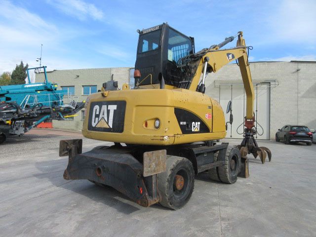 2009 Caterpillar M313D material handler, rear three-quarter view