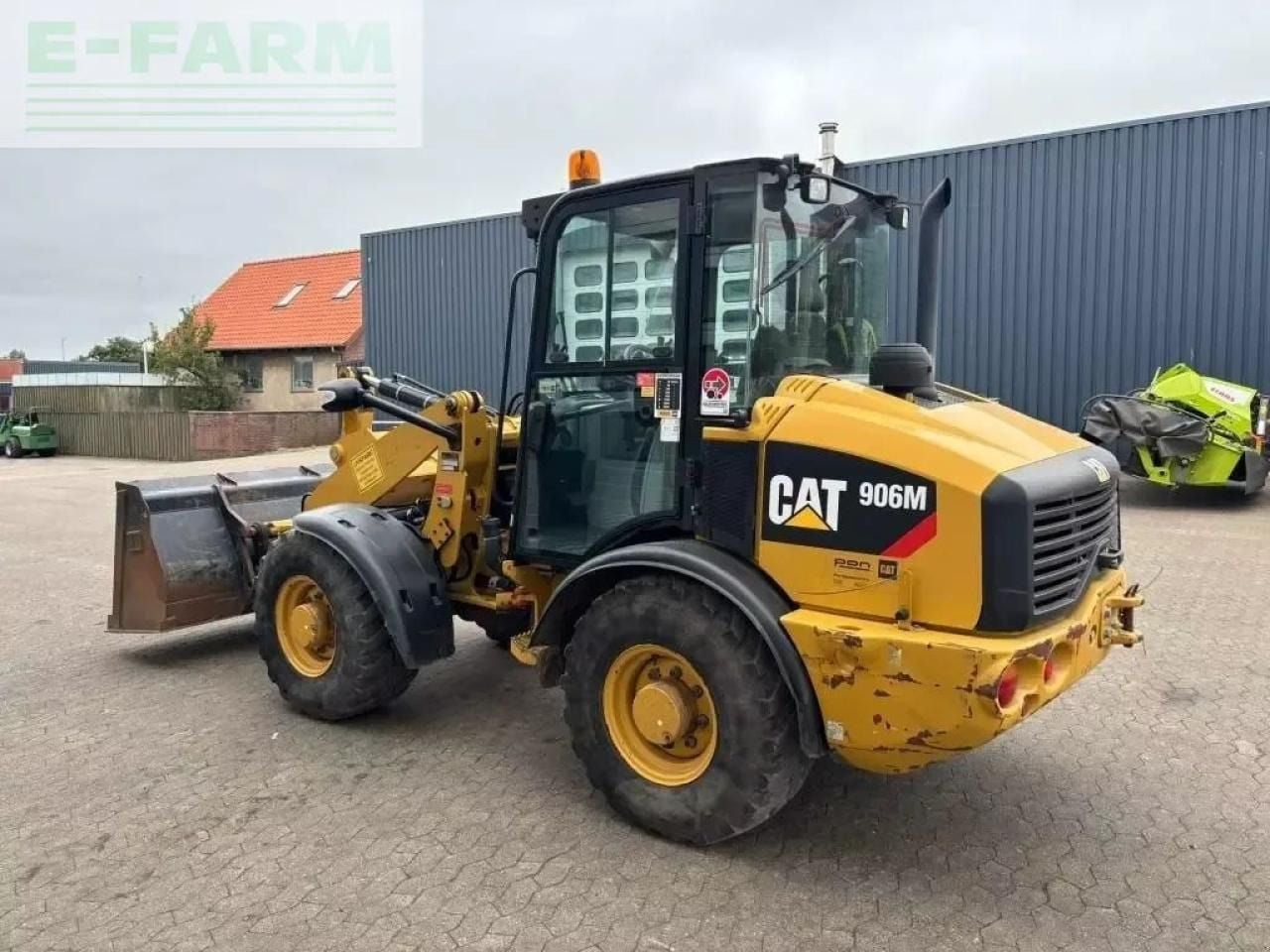2015 Caterpillar 906M wheel loader, rear three-quarter view