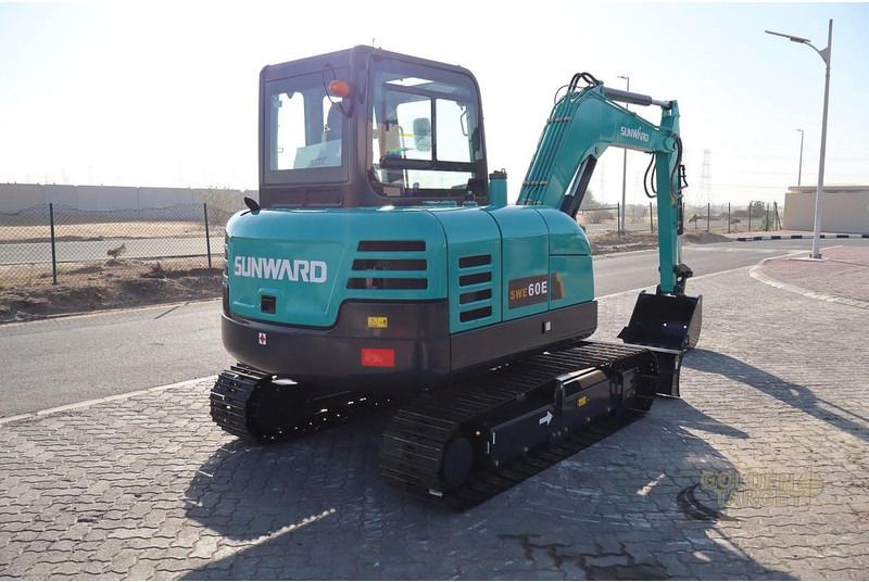 2026 Sunward SWE60E Mini Excavator with its teal body, showing the rear counterweight and the visible model markings.