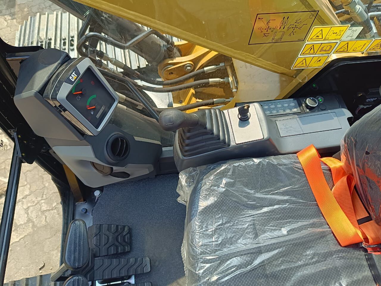 2025 Caterpillar 320D3 Crawler Excavator showing the operator's station with controls and seat. 2025 Caterpillar 320D3 Crawler Excavator showing the operator's station with controls and seat.