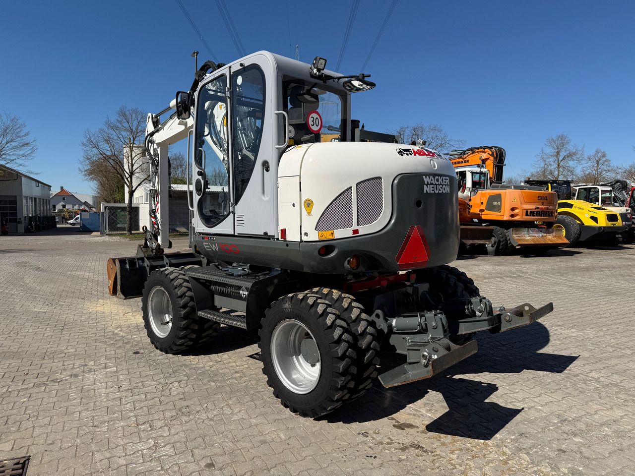 2020 Wacker Neuson EW100 wheel excavator, rear three-quarter view