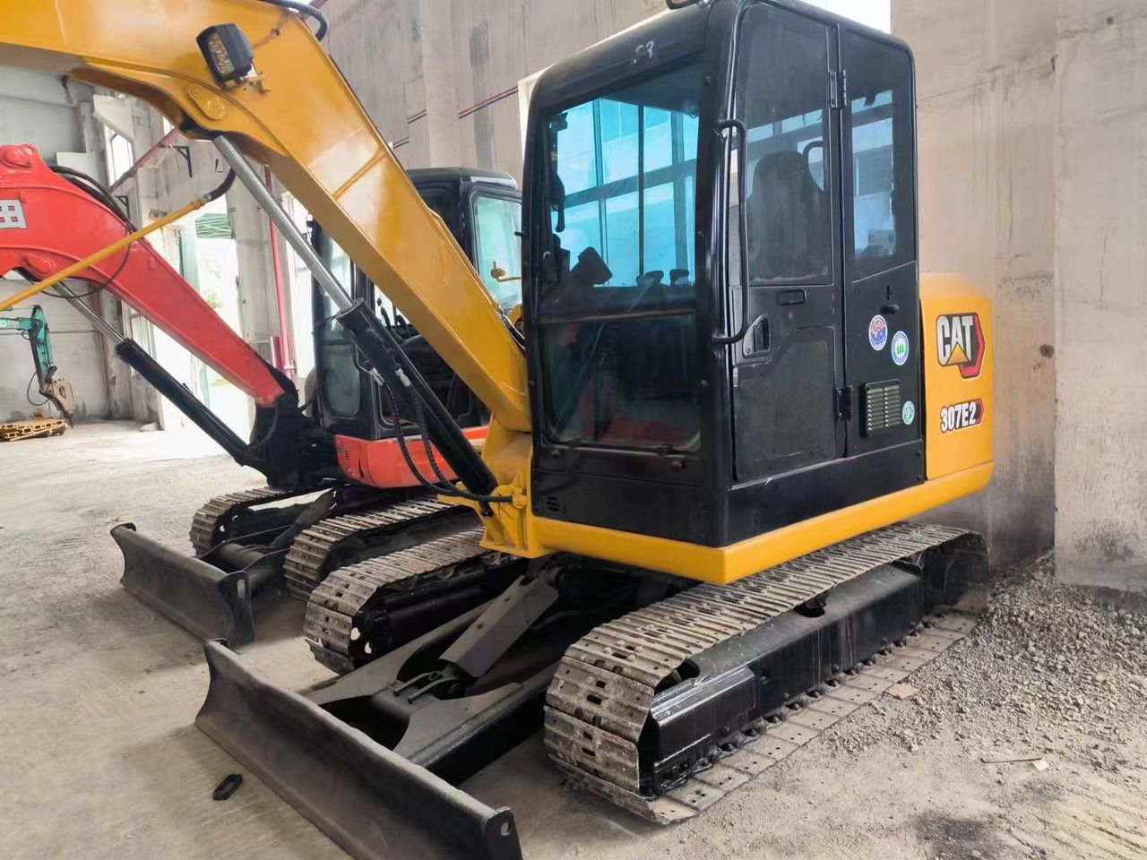 Caterpillar 307E2 mini excavator, front three-quarter view