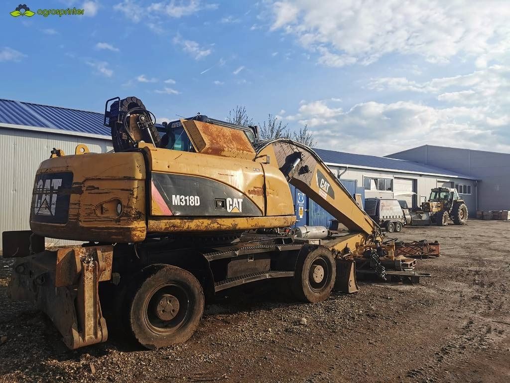 2008 Caterpillar M318D material handler, rear three-quarter view