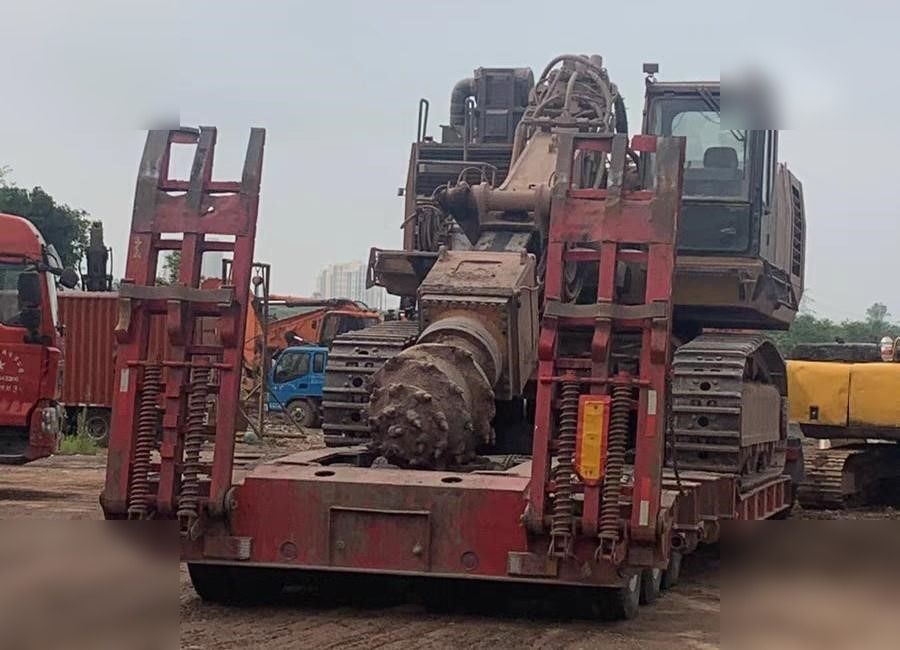 2016 Caterpillar 6015FS crawler excavator on a flatbed trailer
