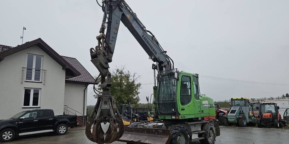 2011 Liebherr A316 LITRONIC wheel excavator, front three-quarter view