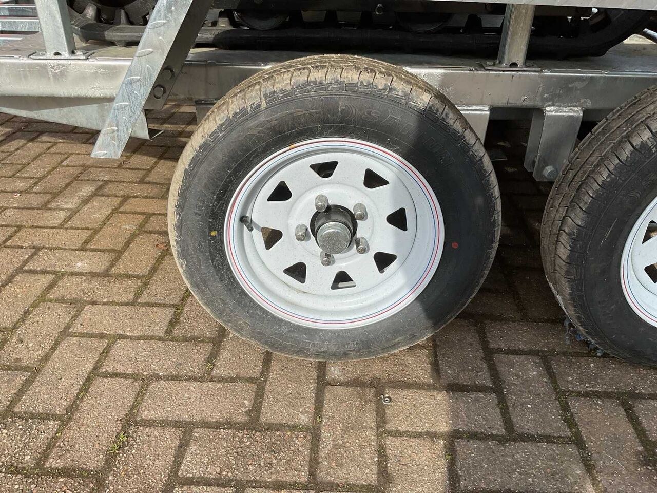 JPC HT-12 mini excavator on trailer, close-up of trailer wheel