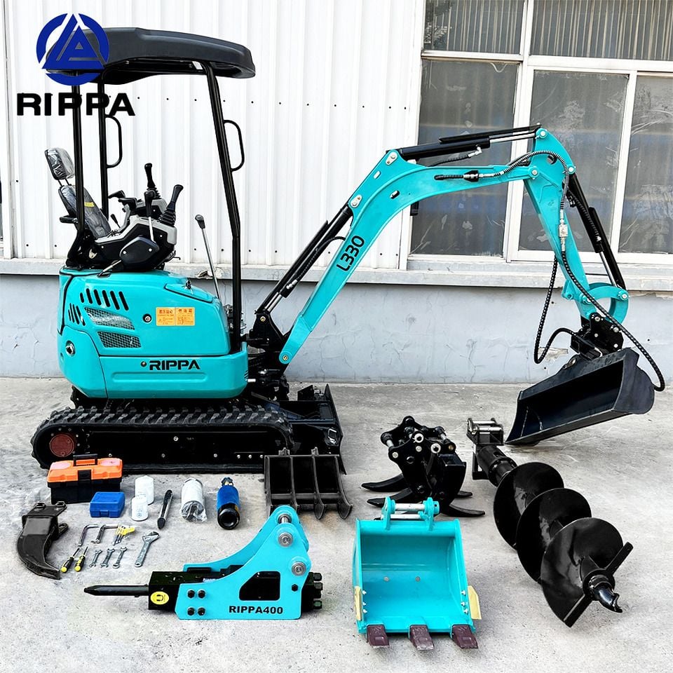 2026 Rippa R322L Mini Excavator with a full array of attachments laid out in front of the machine, including a ripper, auger, and breaker.