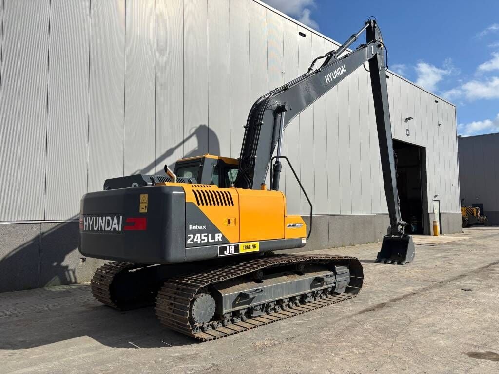 2025 Hyundai R245LR Crawler Excavator from a three-quarter rear view, highlighting the full track assembly and undercarriage.
