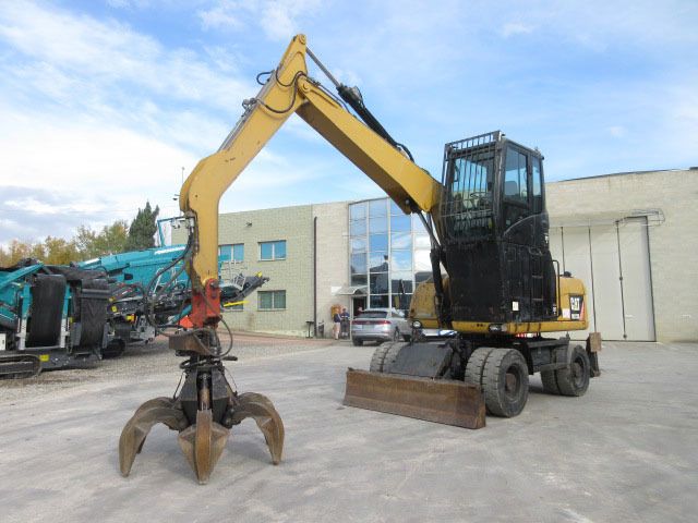 2009 Caterpillar M313D material handler, side view