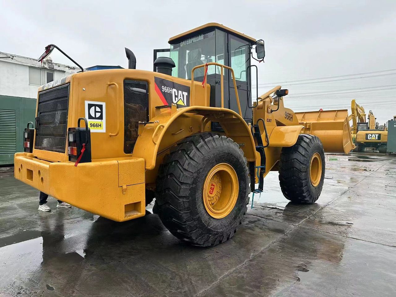 2020 Caterpillar 966H wheel loader, rear three-quarter view 2020 Caterpillar 966H wheel loader, rear three-quarter view