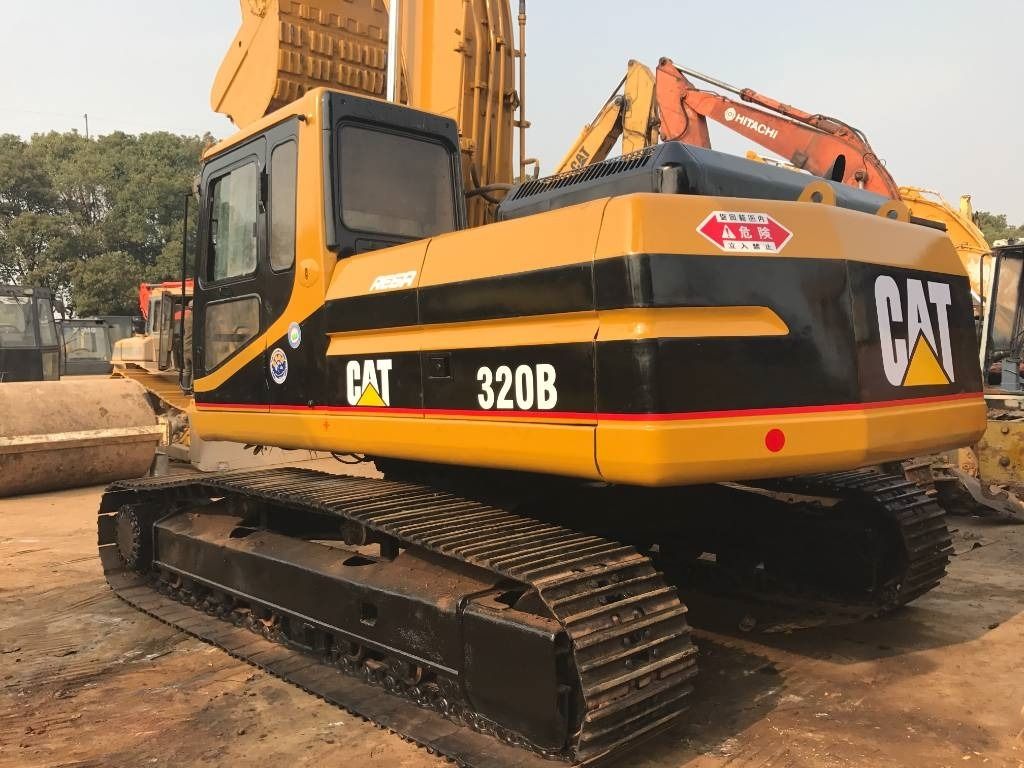 2023 Caterpillar 320B crawler excavator, rear three-quarter view