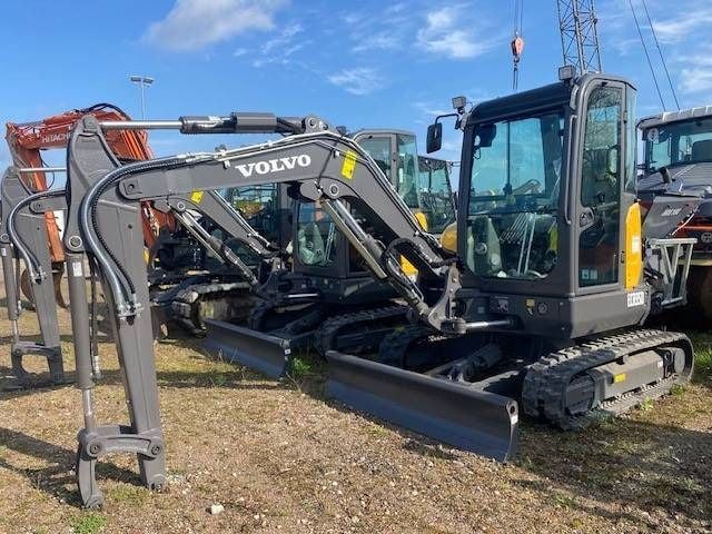2023 Volvo ECR35D Mini Excavator with its gray boom and arm extended forward, showing the dozer blade at the front. 2023 Volvo ECR35D Mini Excavator with its gray boom and arm extended forward, showing the dozer blade at the front.