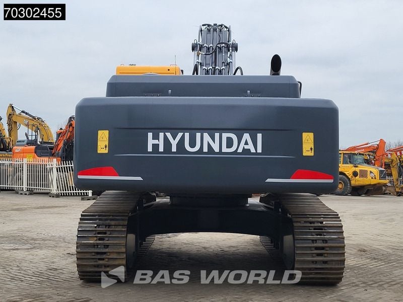 2025 Hyundai R340L Crawler Excavator from the rear, emphasizing the wide dark gray tracks and undercarriage. 2025 Hyundai R340L Crawler Excavator from the rear, emphasizing the wide dark gray tracks and undercarriage.