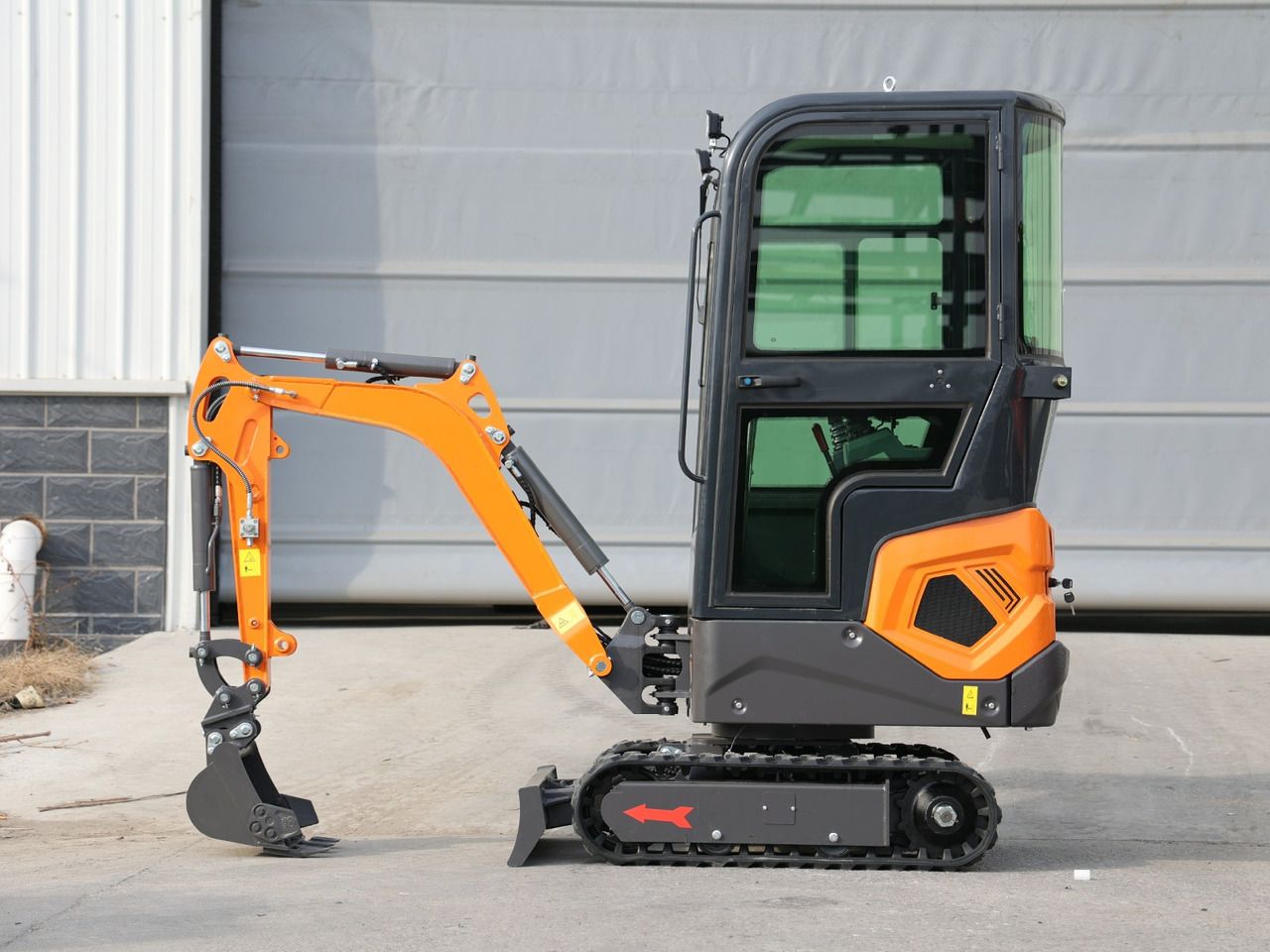 2025 Müller Machinery MB 12-KS H Mini Excavator, side view, with the boom and bucket positioned close to the tracks.