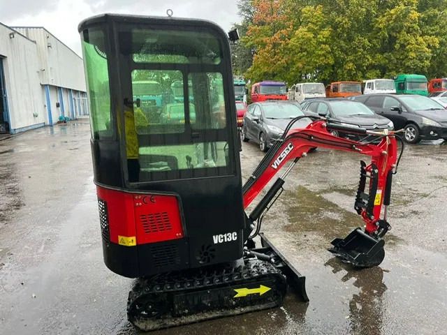 2025 Vicsec VC13C Mini Excavator with red boom and black body, highlighting the operator's cab and controls. 2025 Vicsec VC13C Mini Excavator with red boom and black body, highlighting the operator's cab and controls.