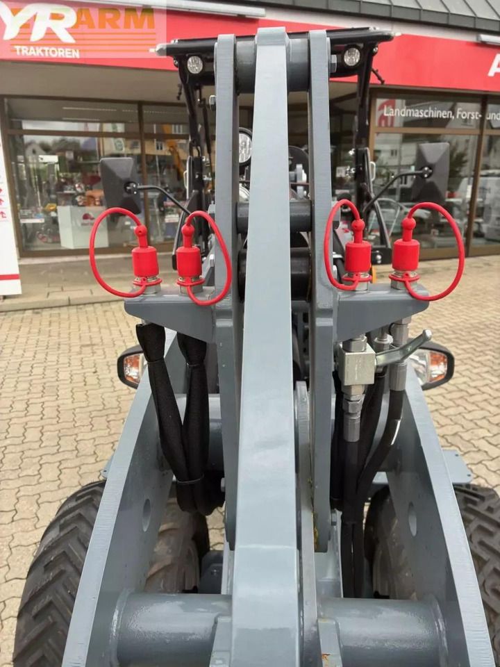 2026 Giant G2500 HD Mini Excavator close-up of red hydraulic quick couplers on the gray loader arm 2026 Giant G2500 HD Mini Excavator close-up of red hydraulic quick couplers on the gray loader arm
