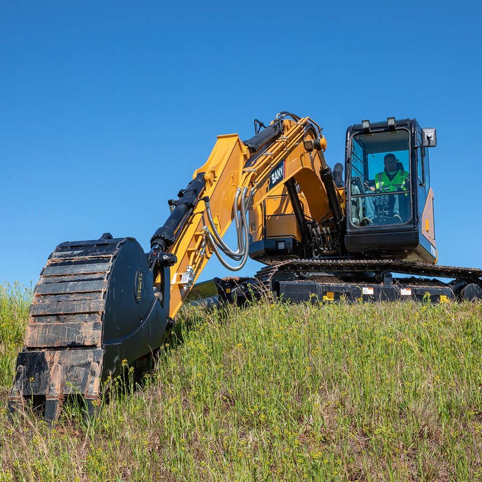2026 Sany SY155U Crawler Excavator with a black bucket attachment and an operator in the cab.