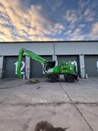 2022 Sennebogen 821 E Material Handler with its bright green boom angled slightly upwards