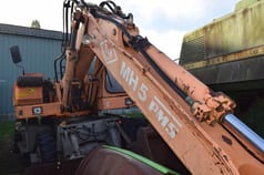 1990 O&K MH 5 wheel excavator, side view of boom and cab