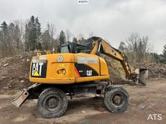 2011 Caterpillar M313D wheel excavator, rear three-quarter view