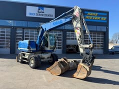 2015 Caterpillar M313D wheel excavator side view