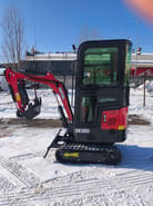 2025 Captok CK13 mini excavator with its red boom and arm extended to the left, showing the bucket and visible CK13CJ model markings.