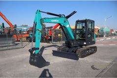 2026 Sunward SWE60E Mini Excavator with its teal body and boom, showcasing the operator's cab and the extended arm.