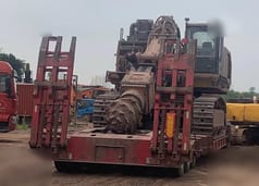 2016 Caterpillar 6015FS crawler excavator on a flatbed trailer