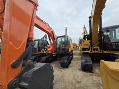 2024 Hitachi ZX135US crawler excavator, front three-quarter view