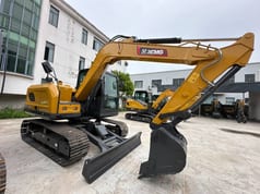 2026 XCMG XE75GA Mini Excavator with its dozer blade lowered and extended forward.