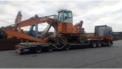 1998 Atlas 1704 MI material handler on a flatbed trailer
