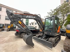 2026 Develon DX60D-10 mini excavator, front three-quarter view