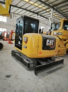 Caterpillar 307E2 mini excavator, rear three-quarter view