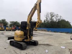 2022 Caterpillar 303.5E mini excavator, rear three-quarter view