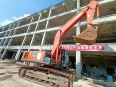 2019 Hitachi ZX360H Crawler Excavator with a front three-quarter view of the orange boom and arm extended. 2019 Hitachi ZX360H Crawler Excavator with a front three-quarter view of the orange boom and arm extended.