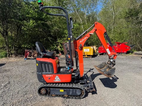 2025 Kubota 008-5 Mini Excavator with the boom and arm extended forward, showing the digging bucket. 2025 Kubota 008-5 Mini Excavator with the boom and arm extended forward, showing the digging bucket.