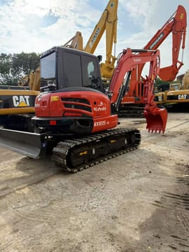 2020 Kubota KX165 WITH THUMB Mini Excavator with its bright orange boom and bucket attachment extended to the side.