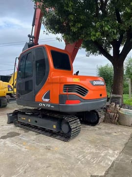 Doosan DX75-9C mini excavator, rear three-quarter view Doosan DX75-9C mini excavator, rear three-quarter view