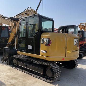Caterpillar 308E2 mini excavator, rear three-quarter view