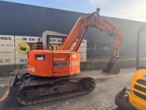 Hitachi EX60UR mini excavator, rear three-quarter view Hitachi EX60UR mini excavator, rear three-quarter view