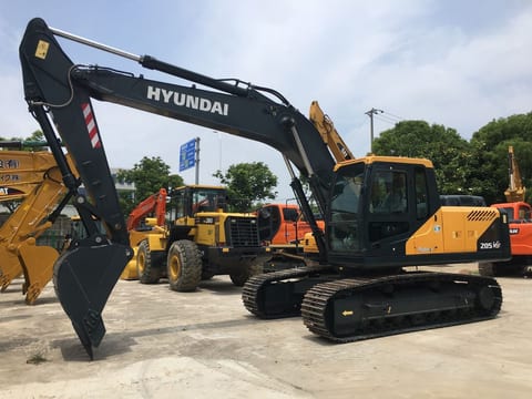 2026 Hyundai 205VS Crawler Excavator with a dark gray boom and arm extending forward, showing the bucket with teeth. 2026 Hyundai 205VS Crawler Excavator with a dark gray boom and arm extending forward, showing the bucket with teeth.